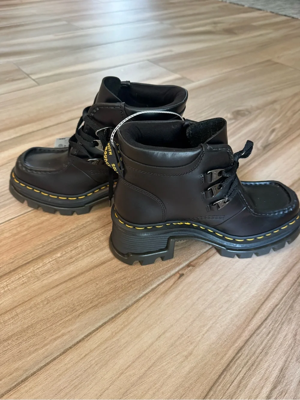 Dr. Martens Black Leather Lug-Sole Ankle Boots with Yellow Stitching